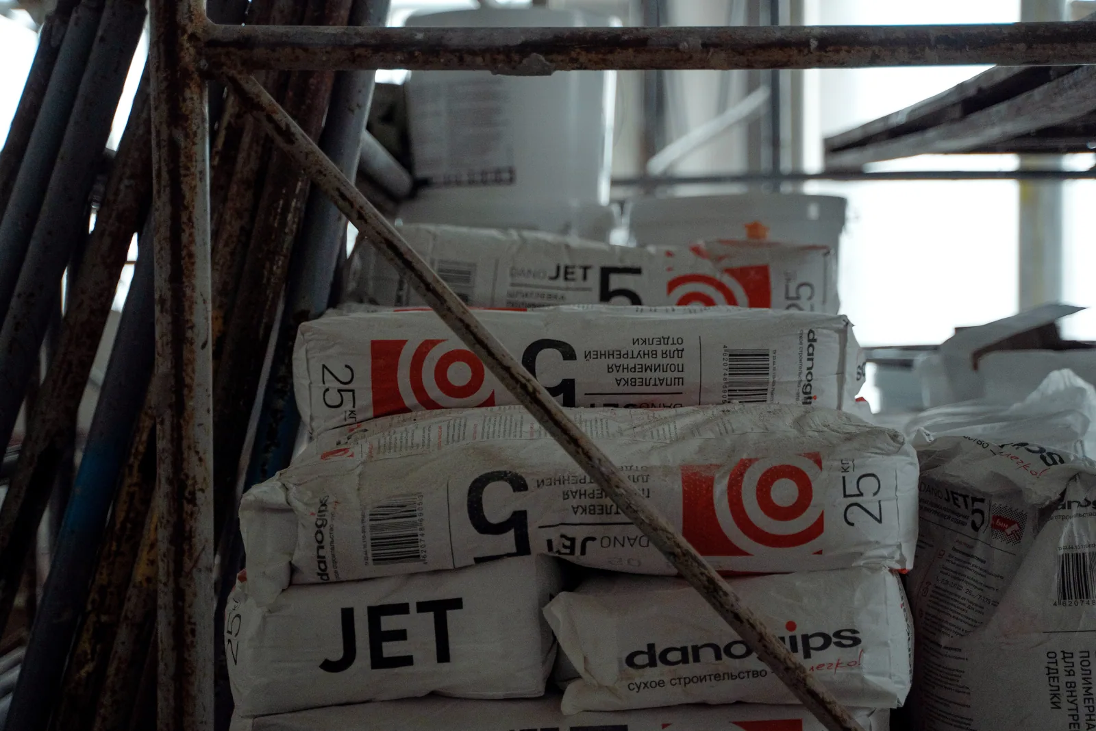 Sacks of cement placed in an indoor construction area, showcasing renovation materials.